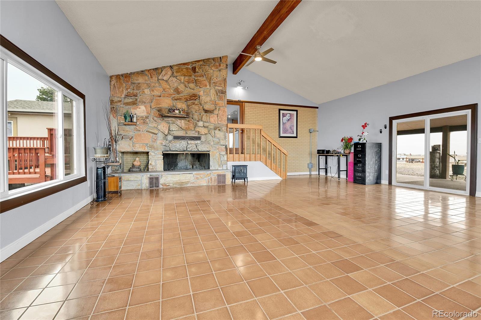 1632 Kiowa-Bennett Road Bennett, CO 80102 - Photo 6 of 42 a living room with furniture and a fireplace