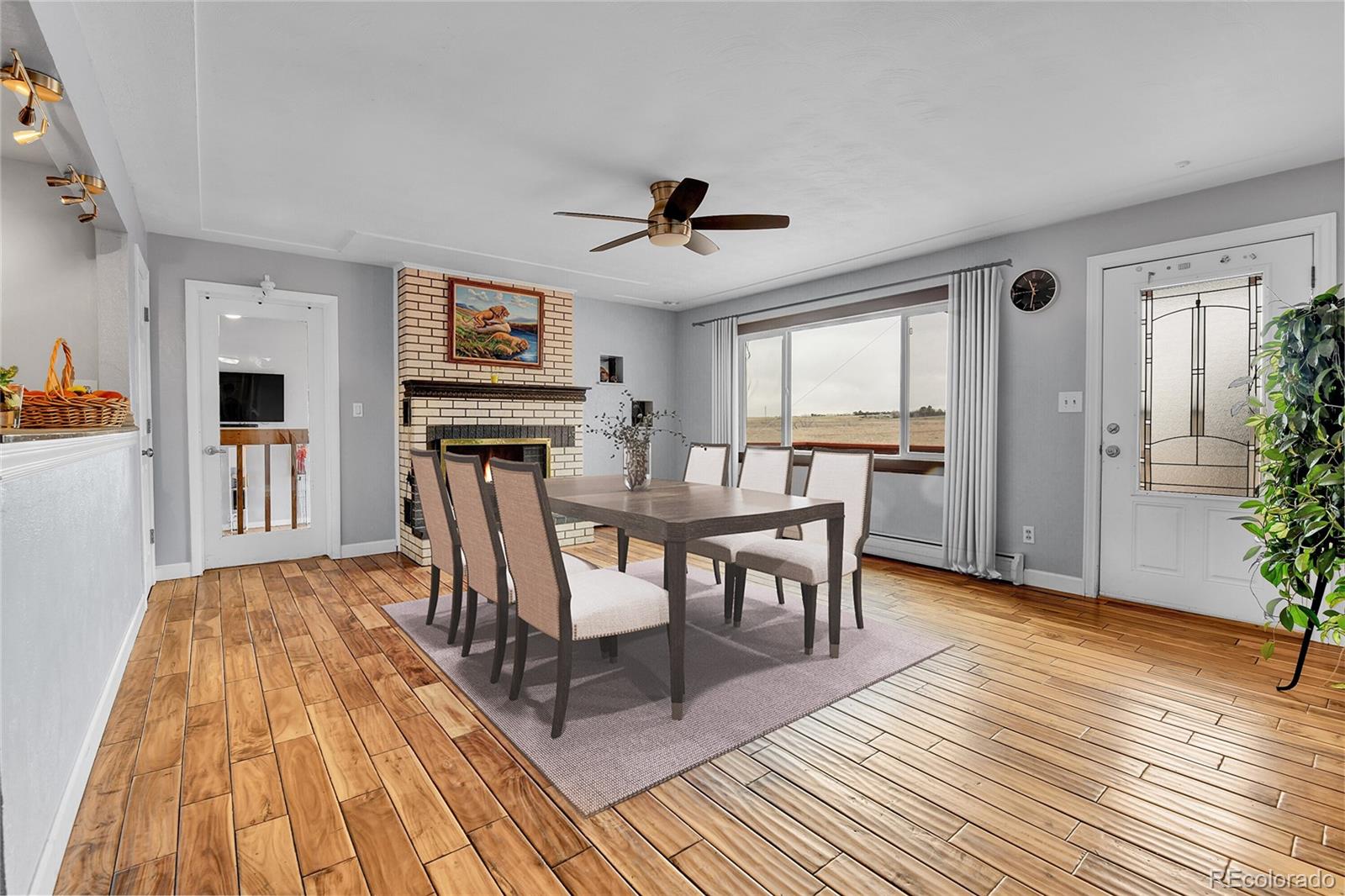 1632 Kiowa-Bennett Road Bennett, CO 80102 - Photo 9 of 42 a view of a dining room with furniture window and wooden floor