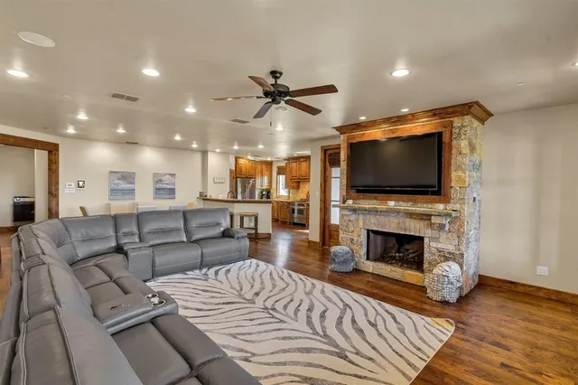 a living room with furniture a flat screen tv and a fireplace