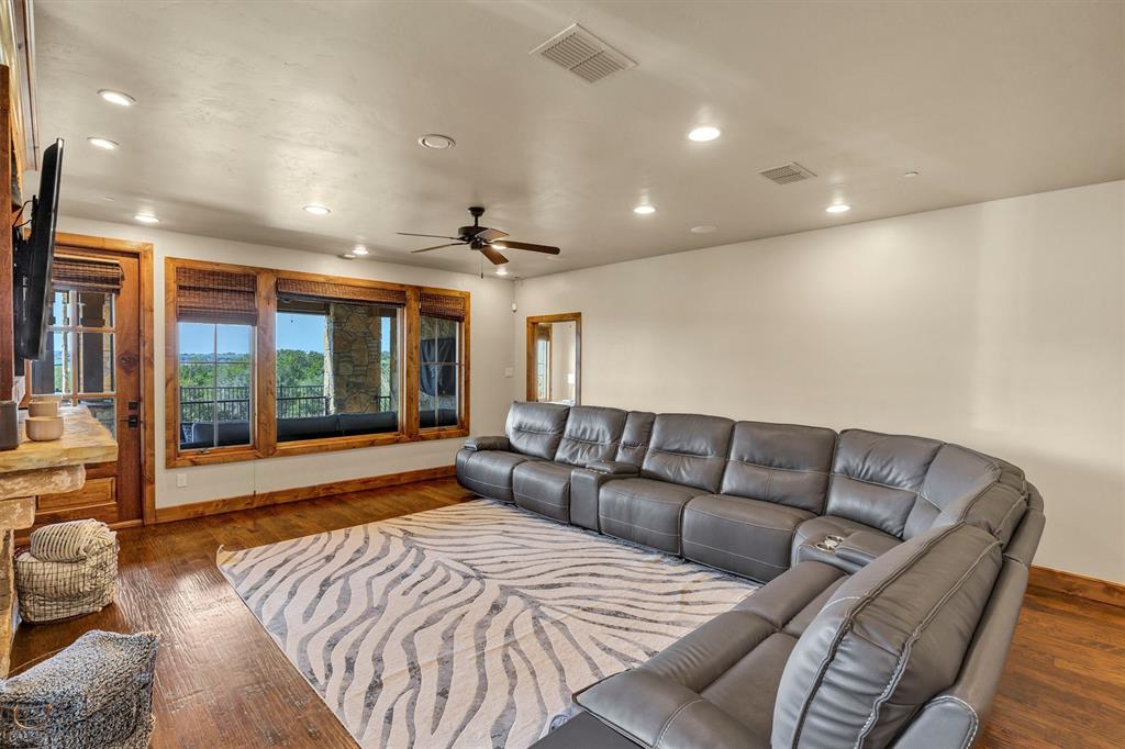 1693 Scenic Drive, Unit 101 Graford, TX 76449 - Photo 13 of 35 a living room with furniture and a large window