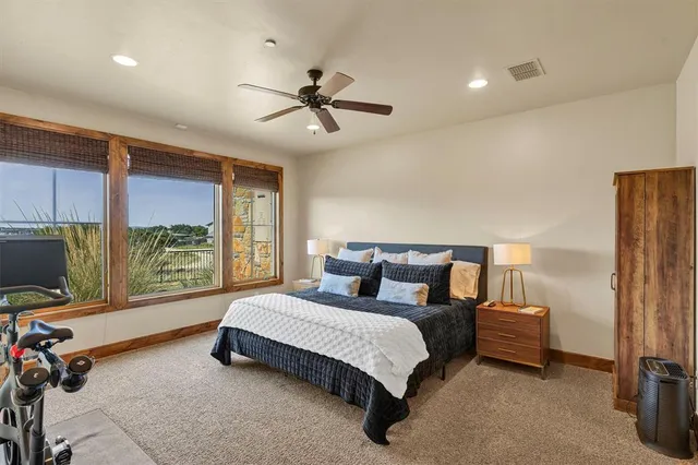 a bedroom with a bed a couch and a window