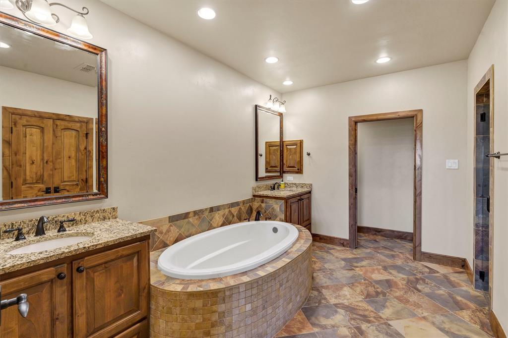 1693 Scenic Drive, Unit 101 Graford, TX 76449 - Photo 17 of 35 a bathroom with a sink and a mirror