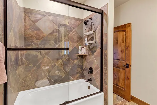 a bathroom with a bathtub and shower