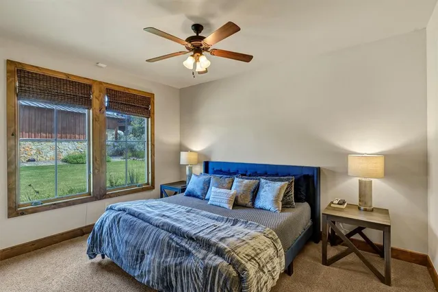 a bedroom with a large bed and a large window