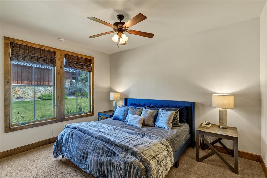 1693 Scenic Drive, Unit 101 Graford, TX 76449 - Photo 23 of 35 a bedroom with a large bed and a large window