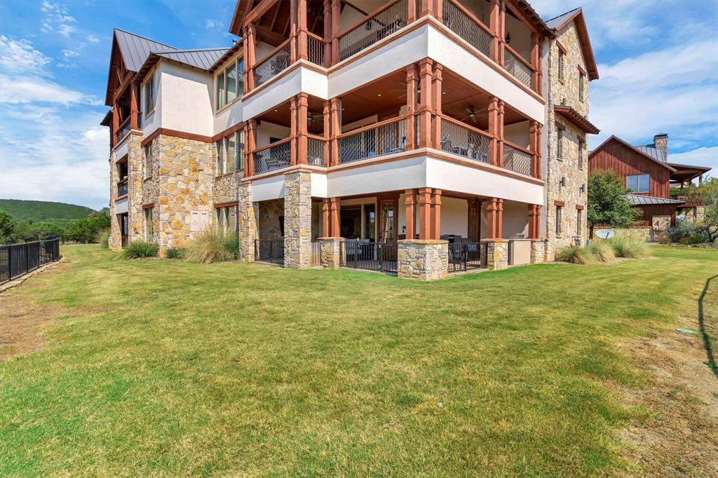 1693 Scenic Drive, Unit 101 Graford, TX 76449 - Photo 29 of 35 a view of a building with a yard