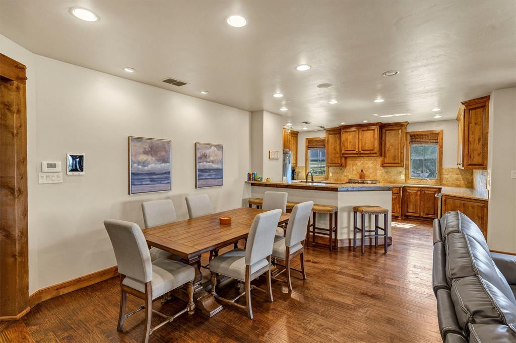 1693 Scenic Drive, Unit 101 Graford, TX 76449 - Photo 4 of 35 a view of a dining area with furniture and wooden floor