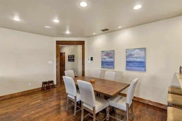 a dining room with furniture and wooden floor