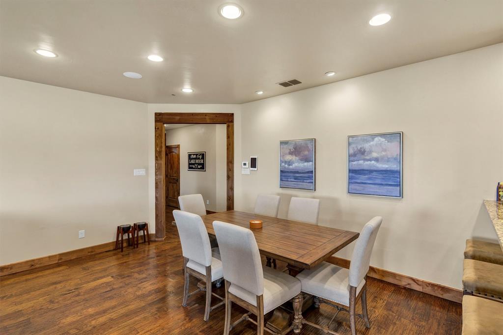 1693 Scenic Drive, Unit 101 Graford, TX 76449 - Photo 5 of 35 a dining room with furniture and wooden floor