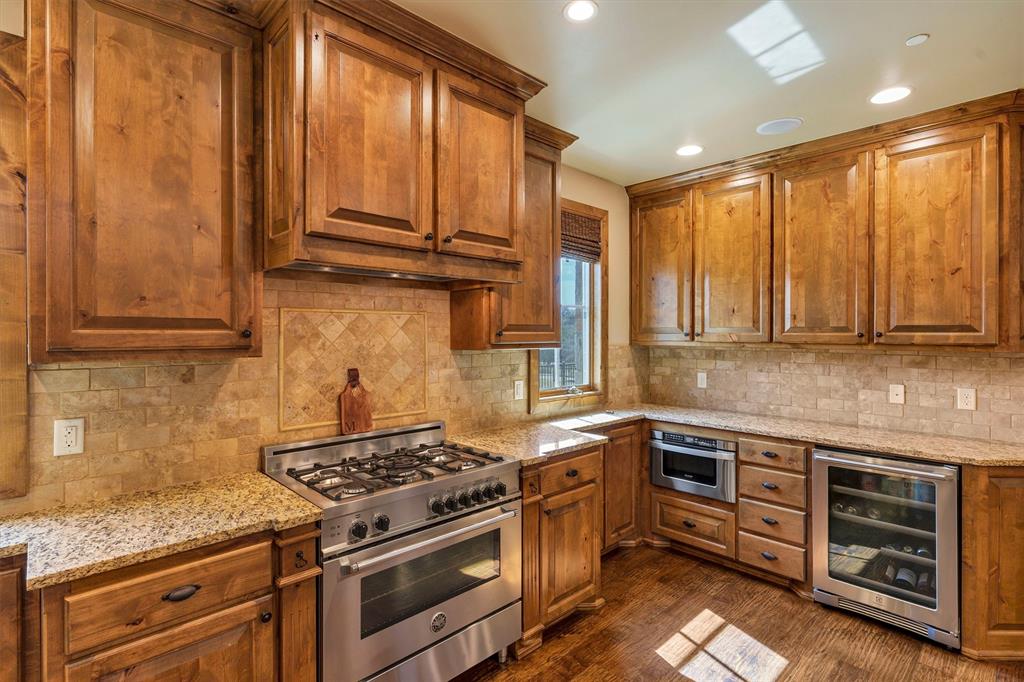 1693 Scenic Drive, Unit 101 Graford, TX 76449 - Photo 8 of 35 a kitchen with stainless steel appliances granite countertop a stove a sink and a microwave
