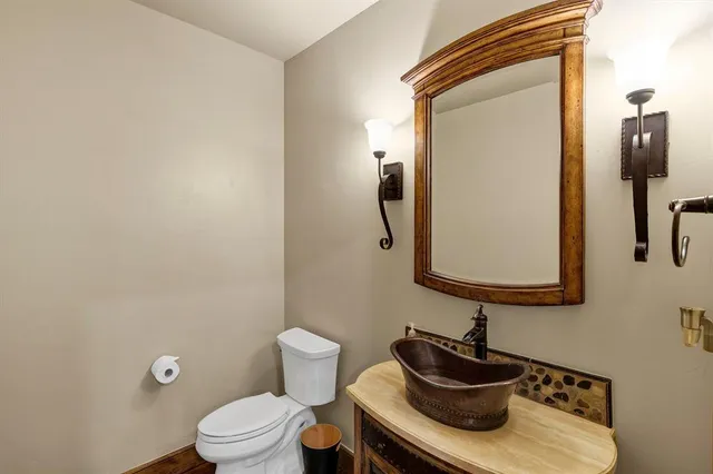 a bathroom with a toilet sink and mirror