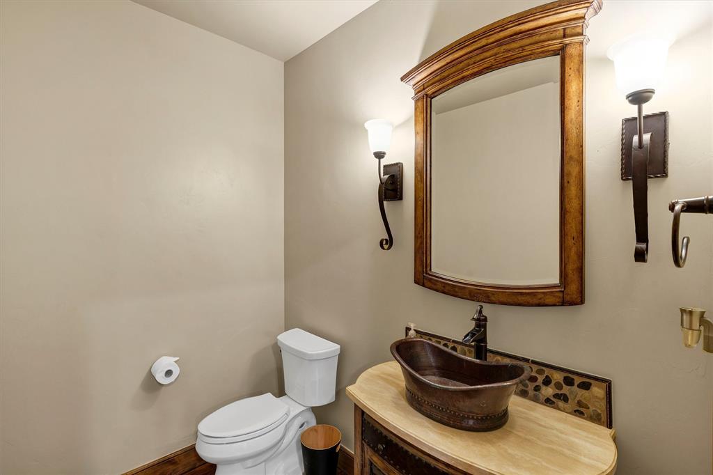 1693 Scenic Drive, Unit 101 Graford, TX 76449 - Photo 10 of 35 a bathroom with a toilet sink and mirror