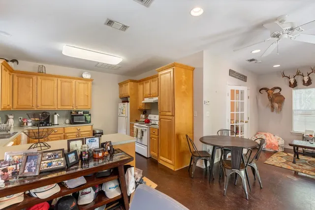 a large white kitchen with a large window