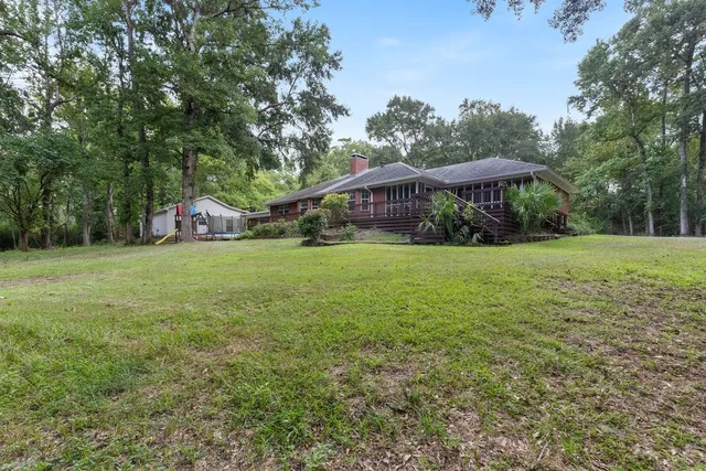 a view of a house with a yard and sitting area