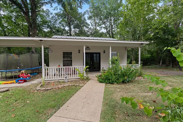 an aerial view of a house with a yard