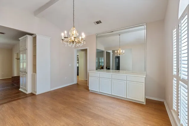 a spacious bathroom with a granite countertop sink a mirror and a shower