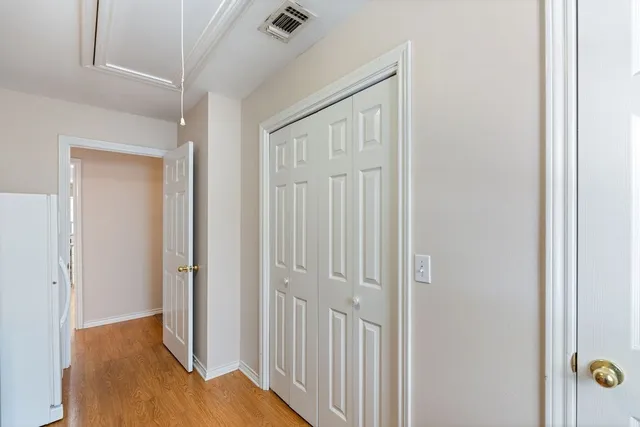 a view of a hallway with wooden floor