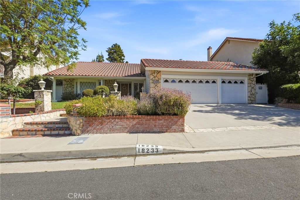 18233 Charlton Lane Porter Ranch, CA 91326 - Photo 2 of 40 a view of a white house with a street