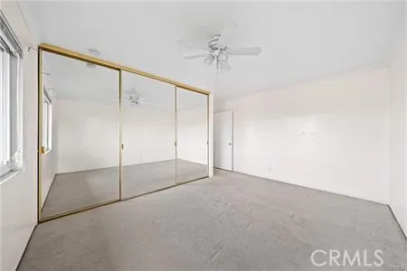 a view of an empty room with a fan