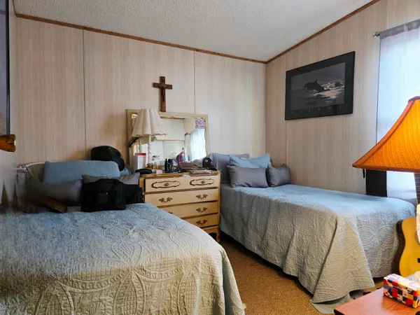 a bedroom with a bed and a painting on the wall