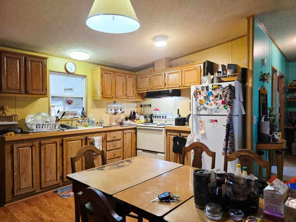 a dining room with furniture and wooden floor