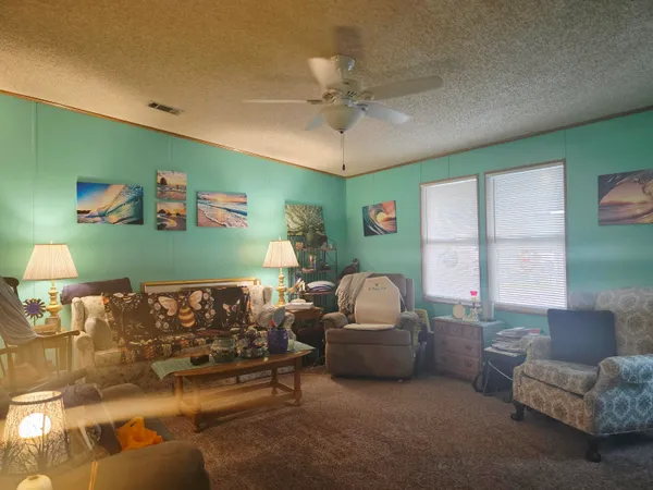 a living room with furniture a window and a flat screen tv