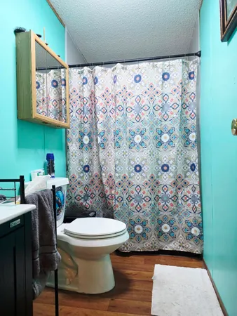 a bathroom with a granite countertop sink and mirror