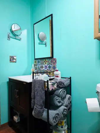 a bedroom with a bed and lamp