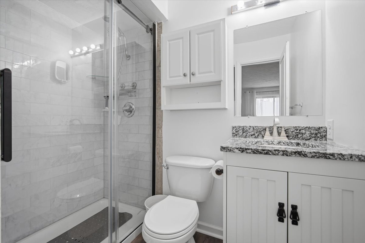 1600 Northbrook Drive, Unit B9 Normal, IL 61761 - Photo 18 of 24 a bathroom with a granite countertop sink toilet a mirror and shower