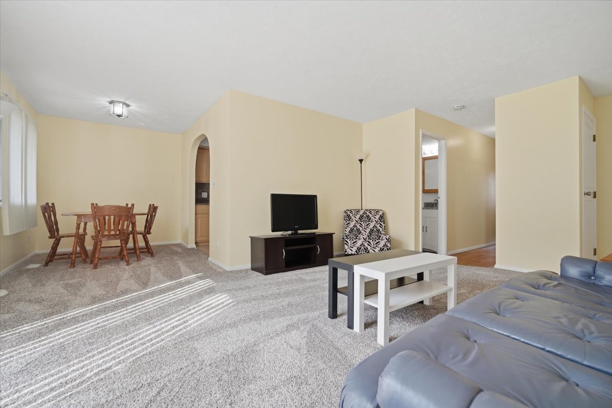 1600 Northbrook Drive, Unit B9 Normal, IL 61761 - Photo 5 of 24 a living room with furniture and a flat screen tv