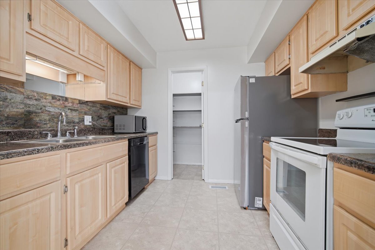 1600 Northbrook Drive, Unit B9 Normal, IL 61761 - Photo 8 of 24 a kitchen with white cabinets and stainless steel appliances