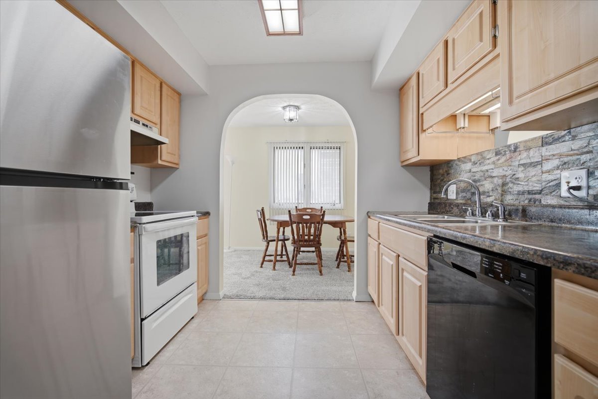 1600 Northbrook Drive, Unit B9 Normal, IL 61761 - Photo 9 of 24 a kitchen with stainless steel appliances granite countertop a refrigerator a stove and a sink with dishwasher