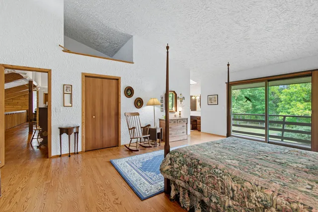 a bed room with a bed and a large window