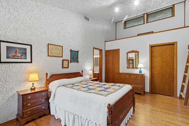 a bedroom with a bed and a table