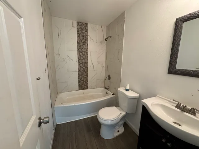 a bathroom with a toilet a sink and bathtub