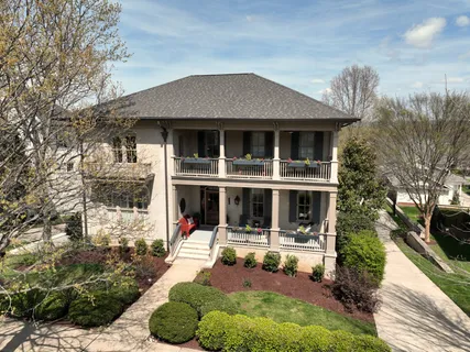 a view of staircase with wooden floor and a chandelier
