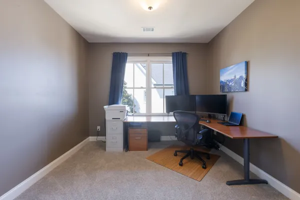 an aerial view of a house with a yard