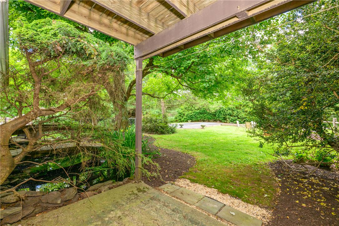 2516 Rachael Lane Orefield, PA 18069 - Photo 34 of 45 A tranquil garden oasis features a serene pond and lush greenery, perfect for peaceful moments.