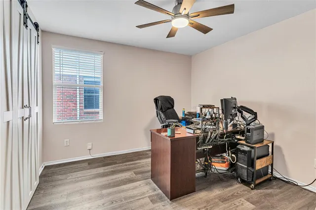 a view of a workspace with furniture and a window