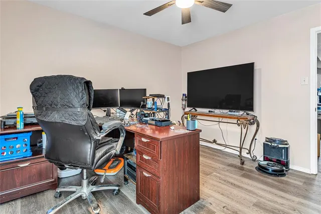 a view of a workspace with furniture and a flat screen tv
