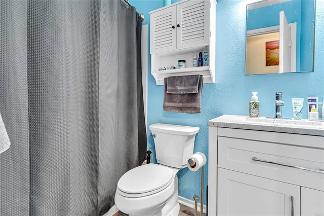 a bathroom with a toilet a sink and a mirror