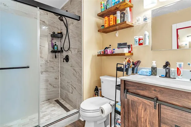 a bathroom with a sink toilet and shower