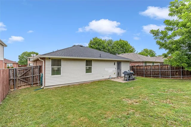 a view of a house with a yard and sitting area