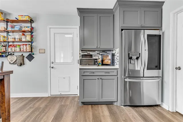a kitchen with stainless steel appliances a refrigerator and cabinets