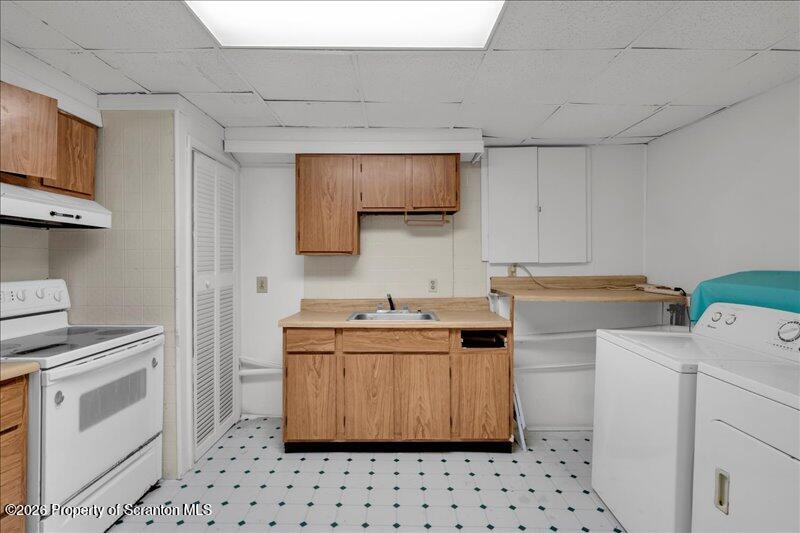 1228 Lake Road Factoryville, PA 18419 - Photo 15 of 43 a kitchen with a stove sink and cabinets