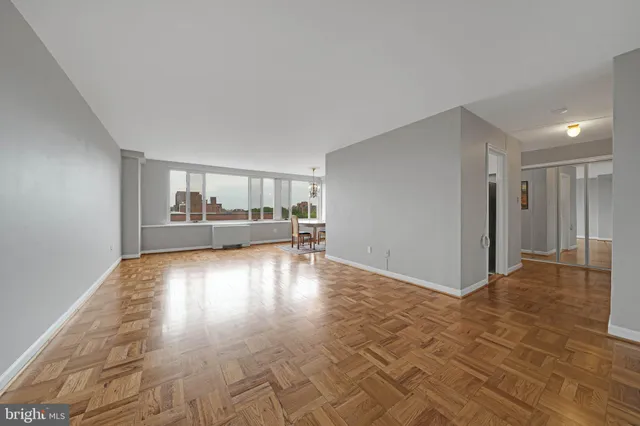 a view of empty room with wooden floor