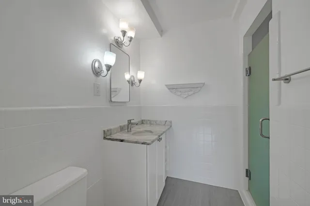 a bathroom with a sink a toilet and a mirror