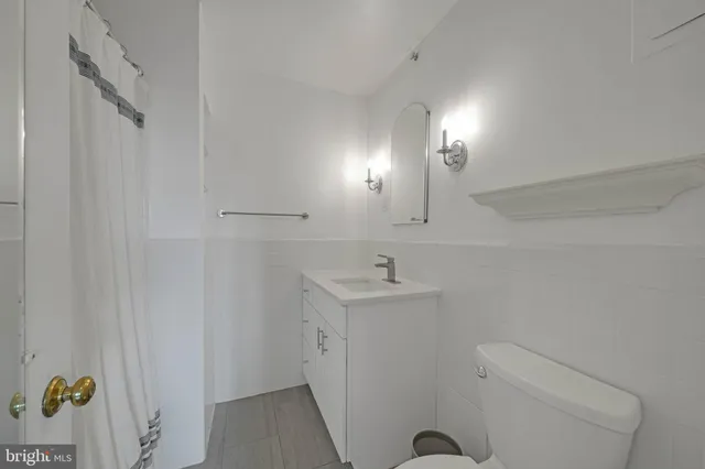 a bathroom with a sink toilet and mirror