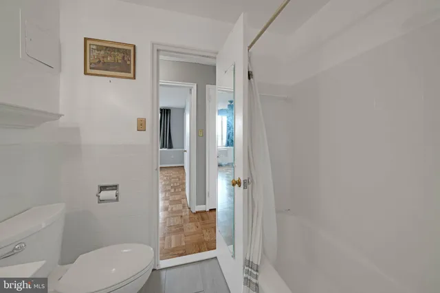 a bathroom with a toilet and a shower