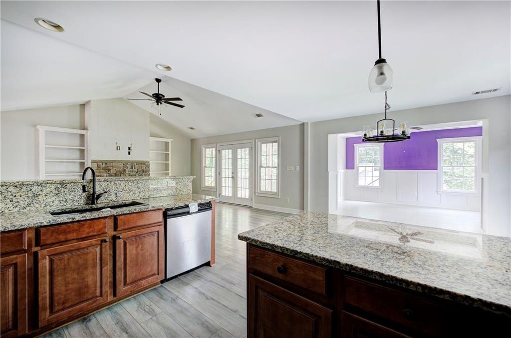 561 Holland Road Dallas, GA 30157 - Photo 13 of 48 a kitchen with granite countertop a sink cabinets and wooden floor